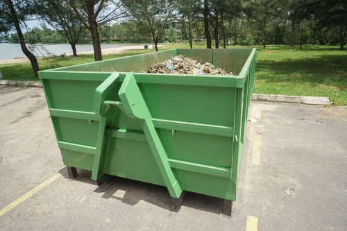 Workers handling wood and masonry waste in Clapham